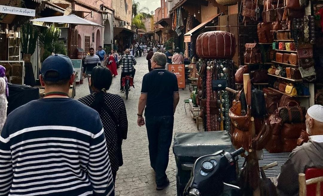 Happy travelers with a licensed local guide during a private Marrakech Medina guided tour