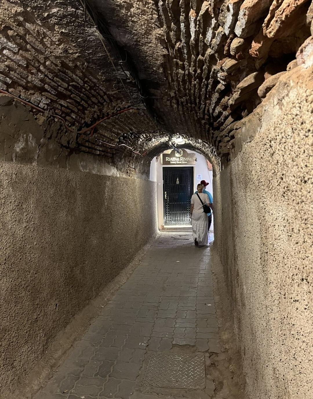 Covered narrow alley with traditional arch in Marrakech Medina