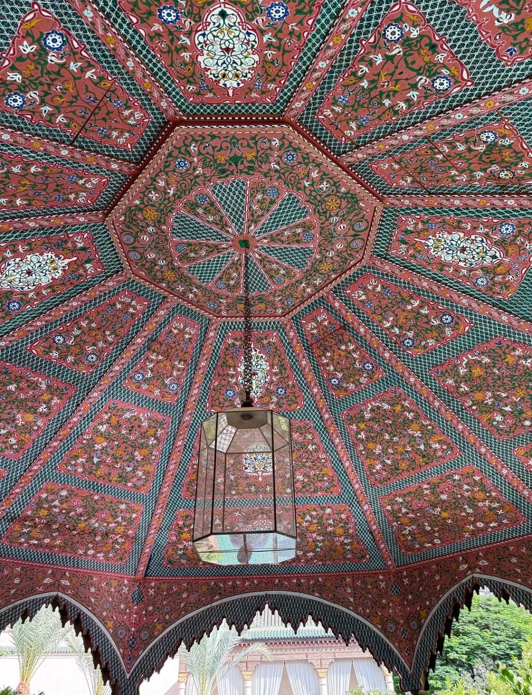 Ornate wooden ceiling inside Le Jardin Secret in Marrakech Medina