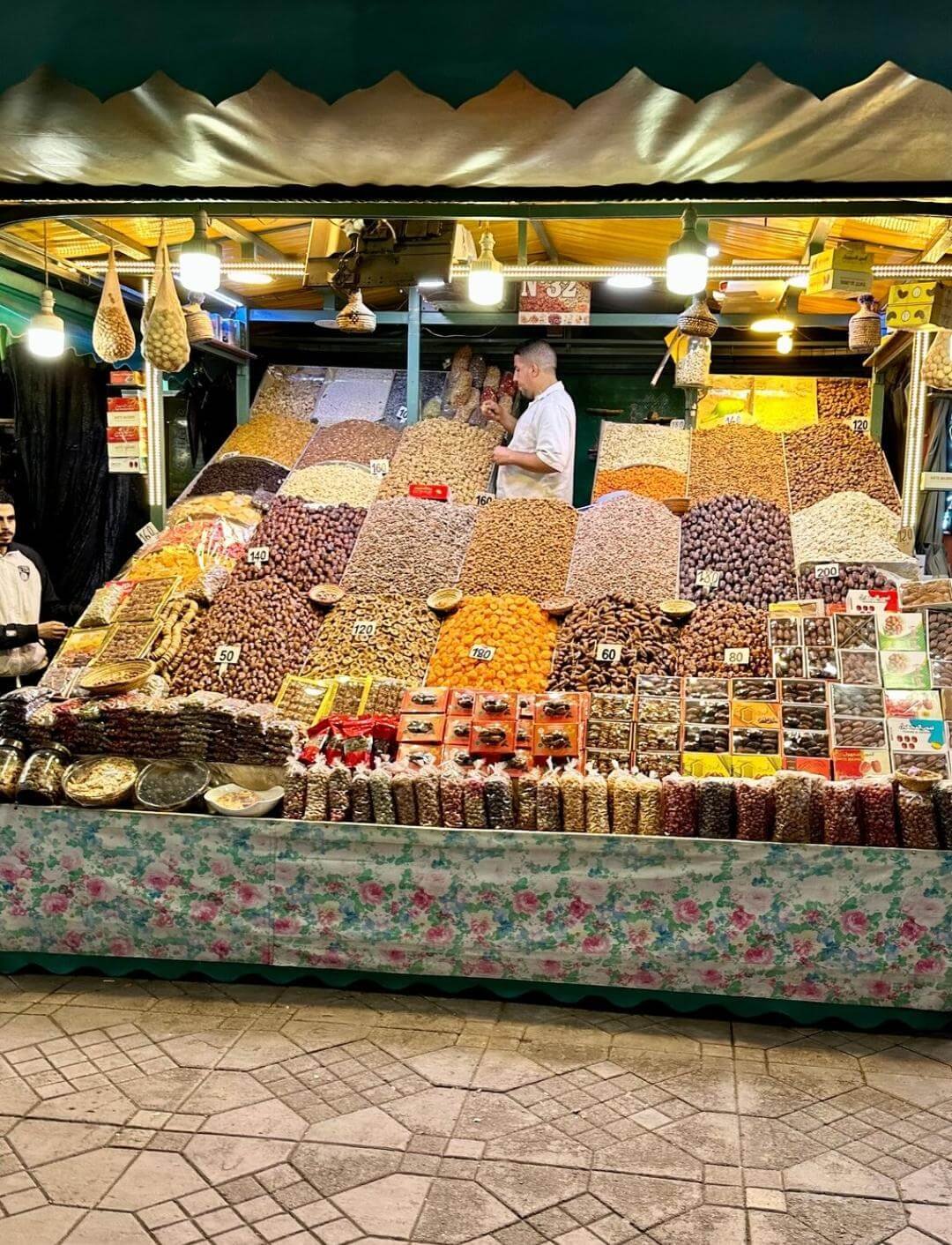 Traditional dry fruit vendor in Jemaa El Fna during a private Marrakech Medina guided tour