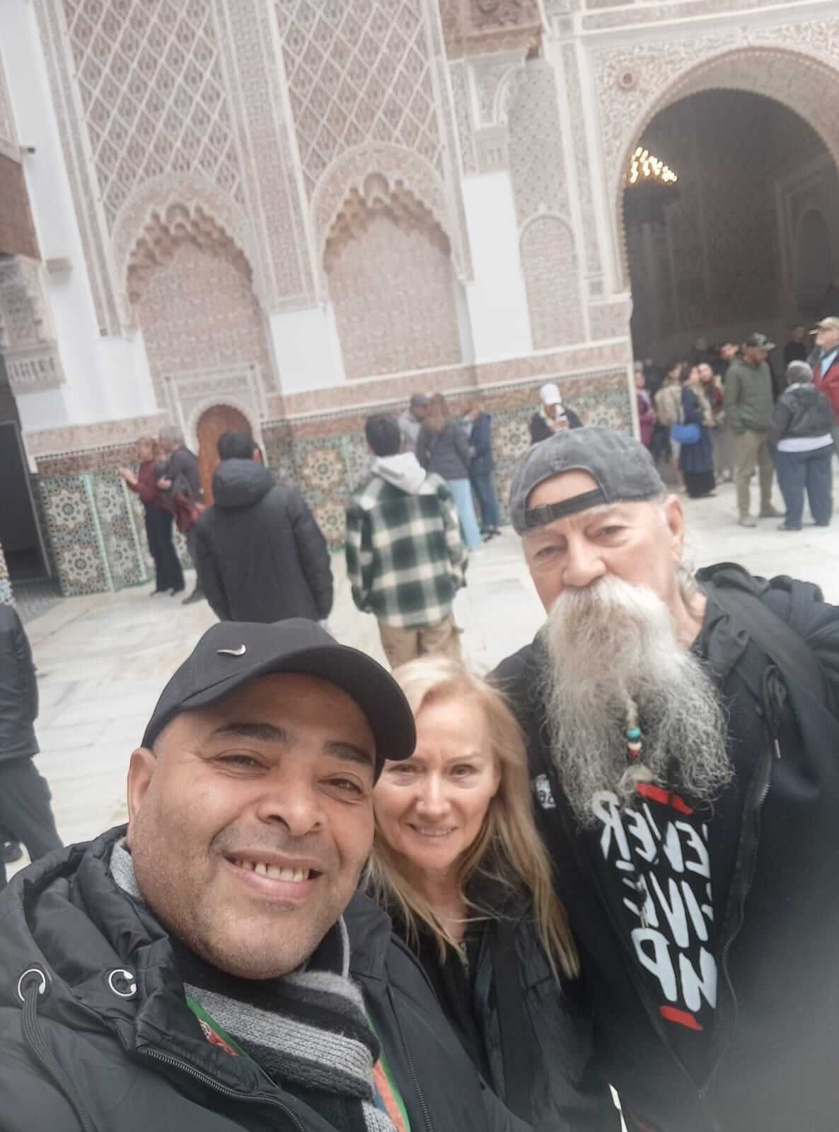 Licensed Marrakech tour guide with happy travelers during a private Medina tour