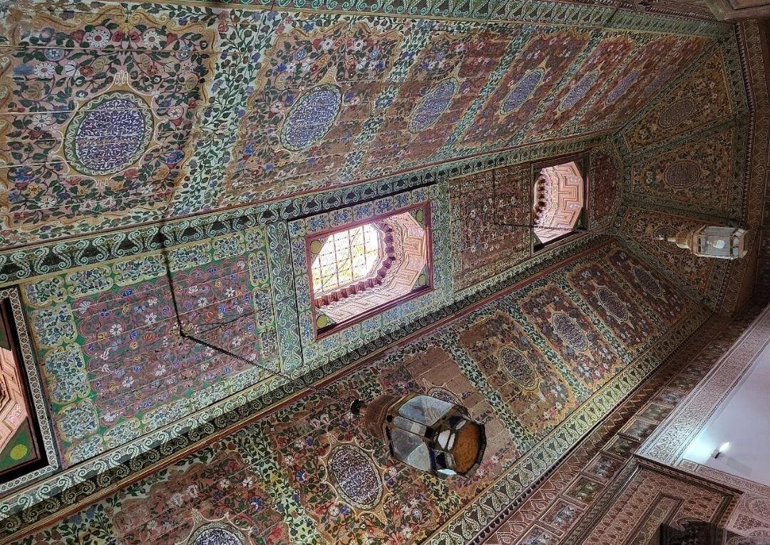 Intricate wooden ceiling and traditional Moroccan decorations inside Bahia Palace in Marrakech