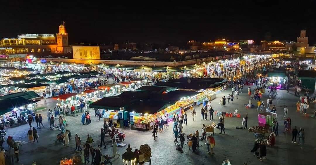 Jemaa el-Fnaa square illuminated at night, aerial view