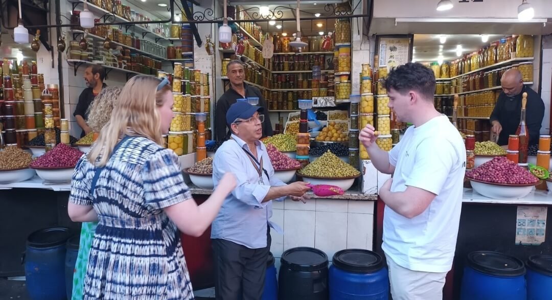 Local guide and client tasting traditional Moroccan olives in Marrakech