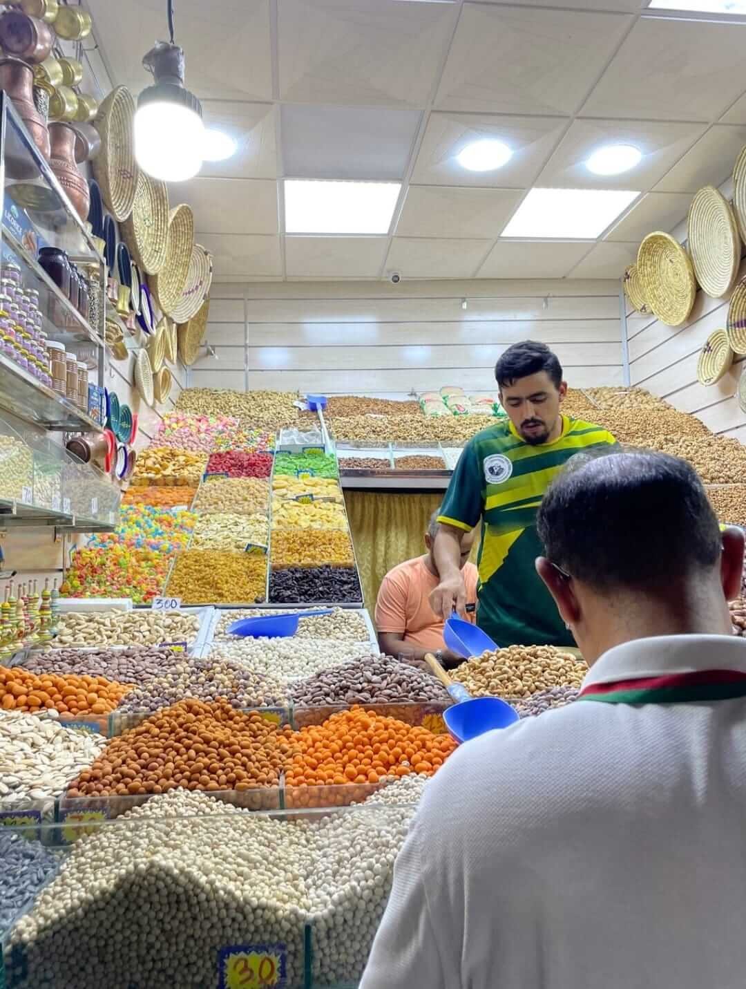 Local guide and client tasting Moroccan dry fruits in Marrakech