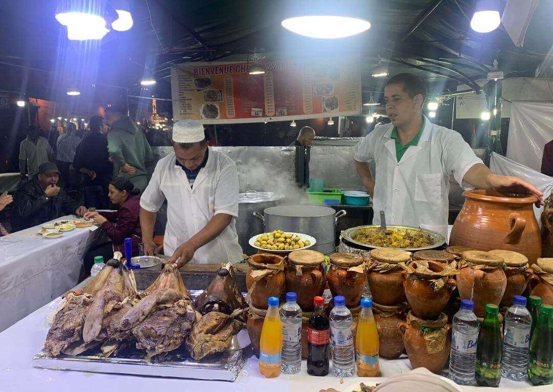 Street food vendors preparing traditional dishes in Marrakech market