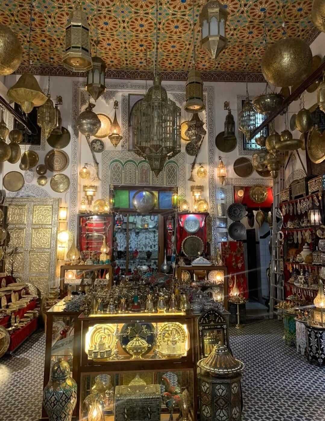 Traditional Moroccan lanterns and brassware inside Marrakech souk shop
