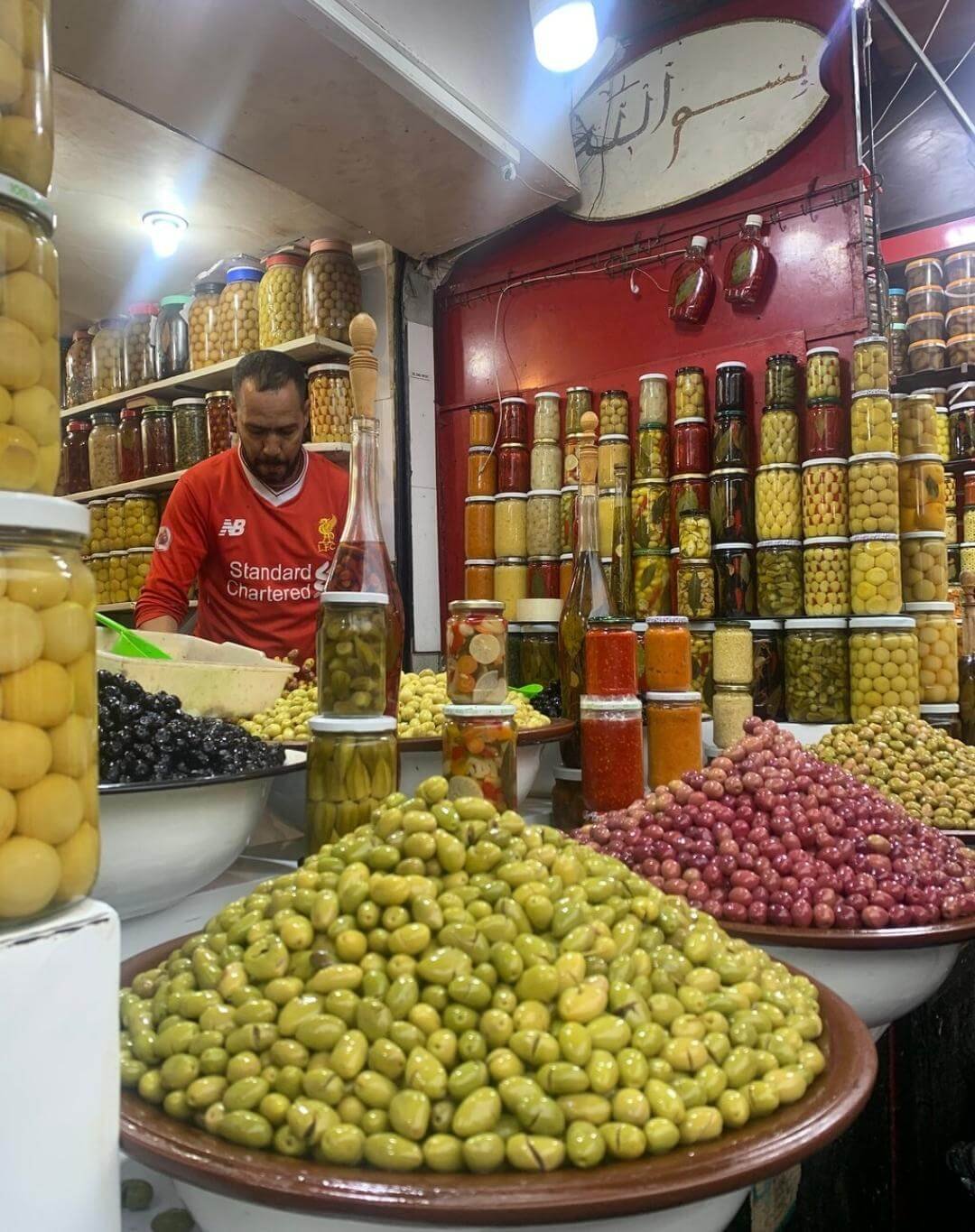 Olive vendor at a traditional Marrakech market stall