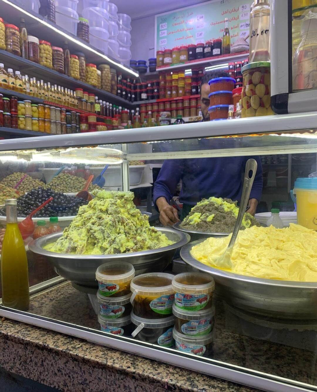 Marrakech street food market with olive and goods stalls