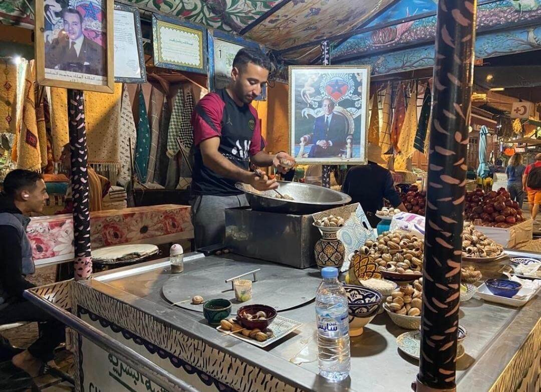Vendor frying traditional Moroccan sfenj doughnuts