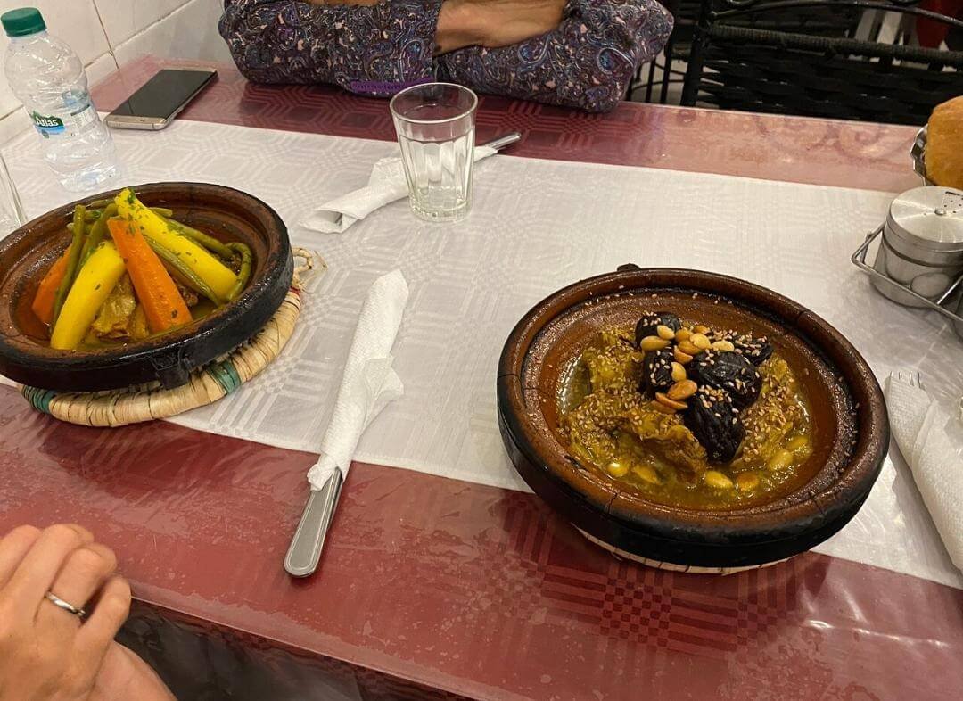 Two Moroccan tagines served on a restaurant table
