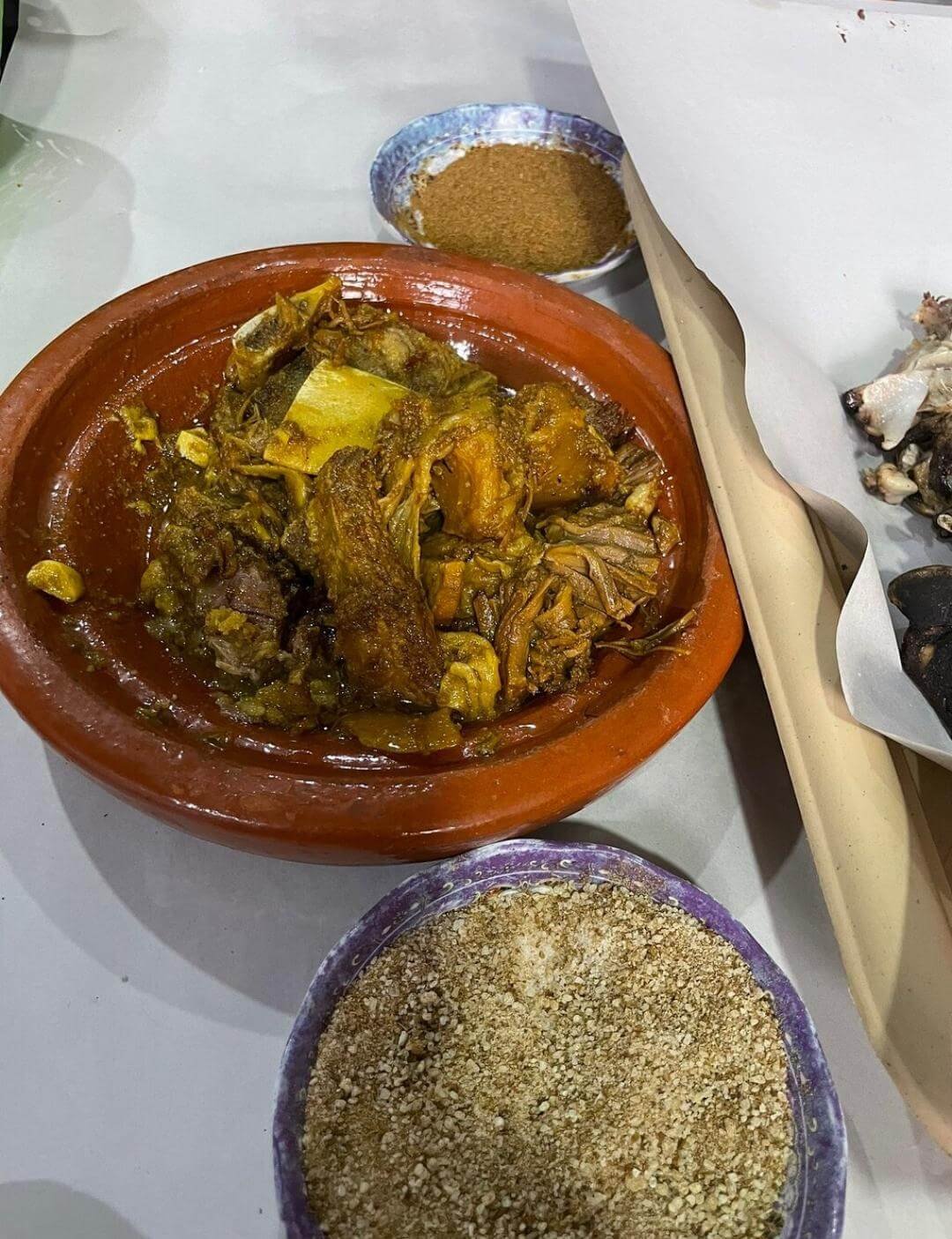 Overhead view of Moroccan tagine with bread