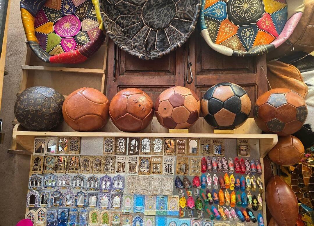 Leather balls and colorful textiles in Marrakech shop