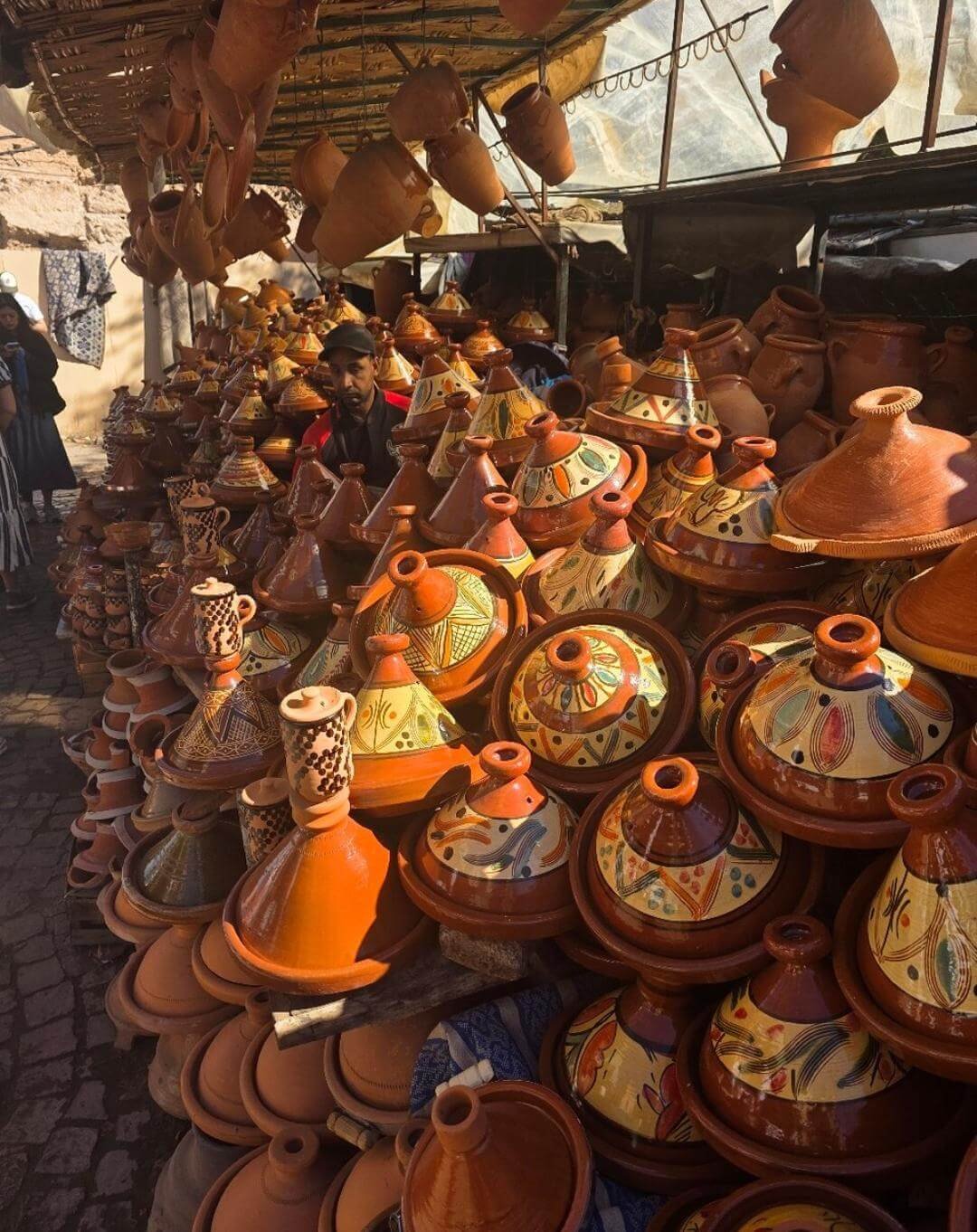 Stacks of traditional tagine pottery in Marrakech souk