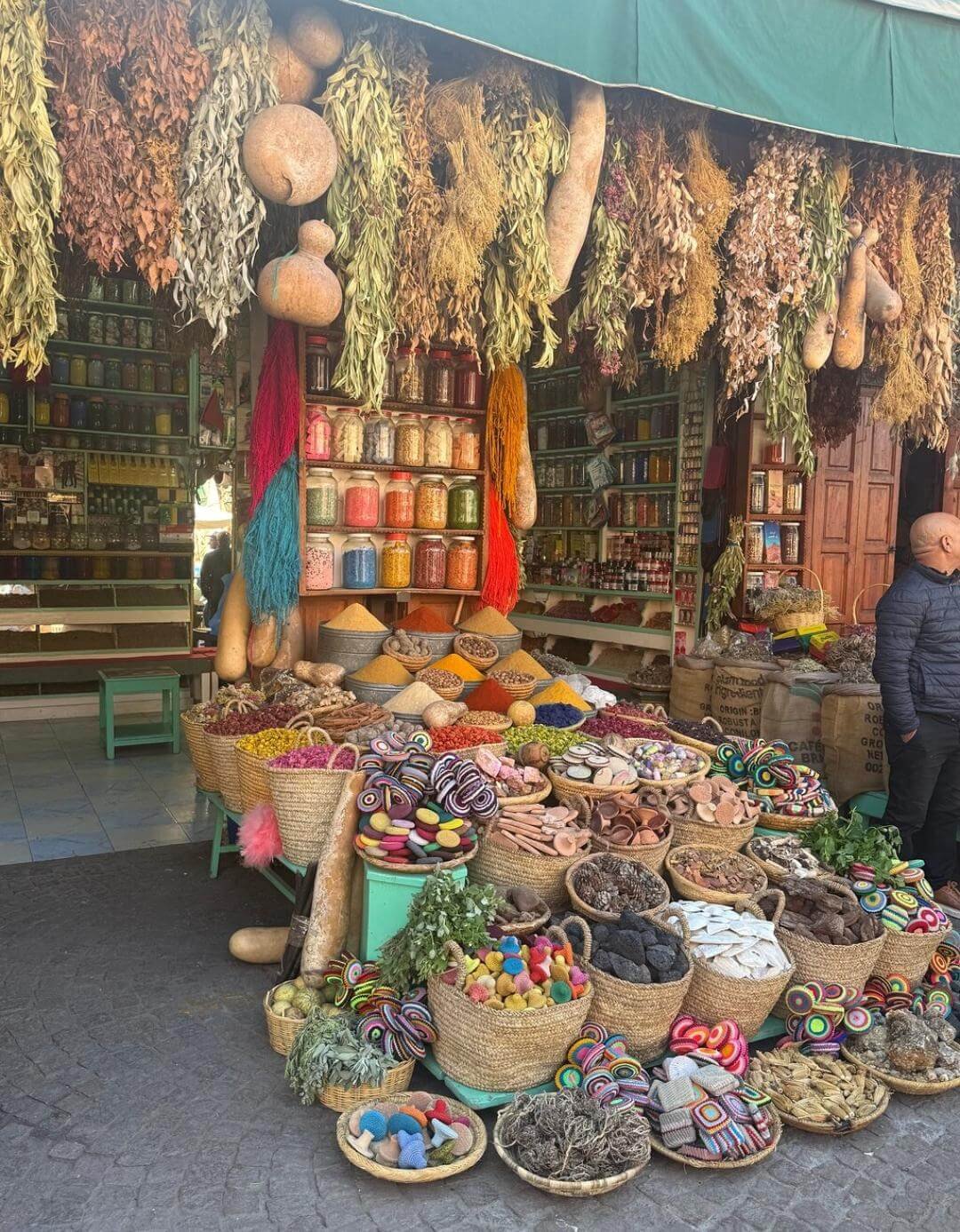 Traditional spices and herbs hanging in Marrakech souk shop