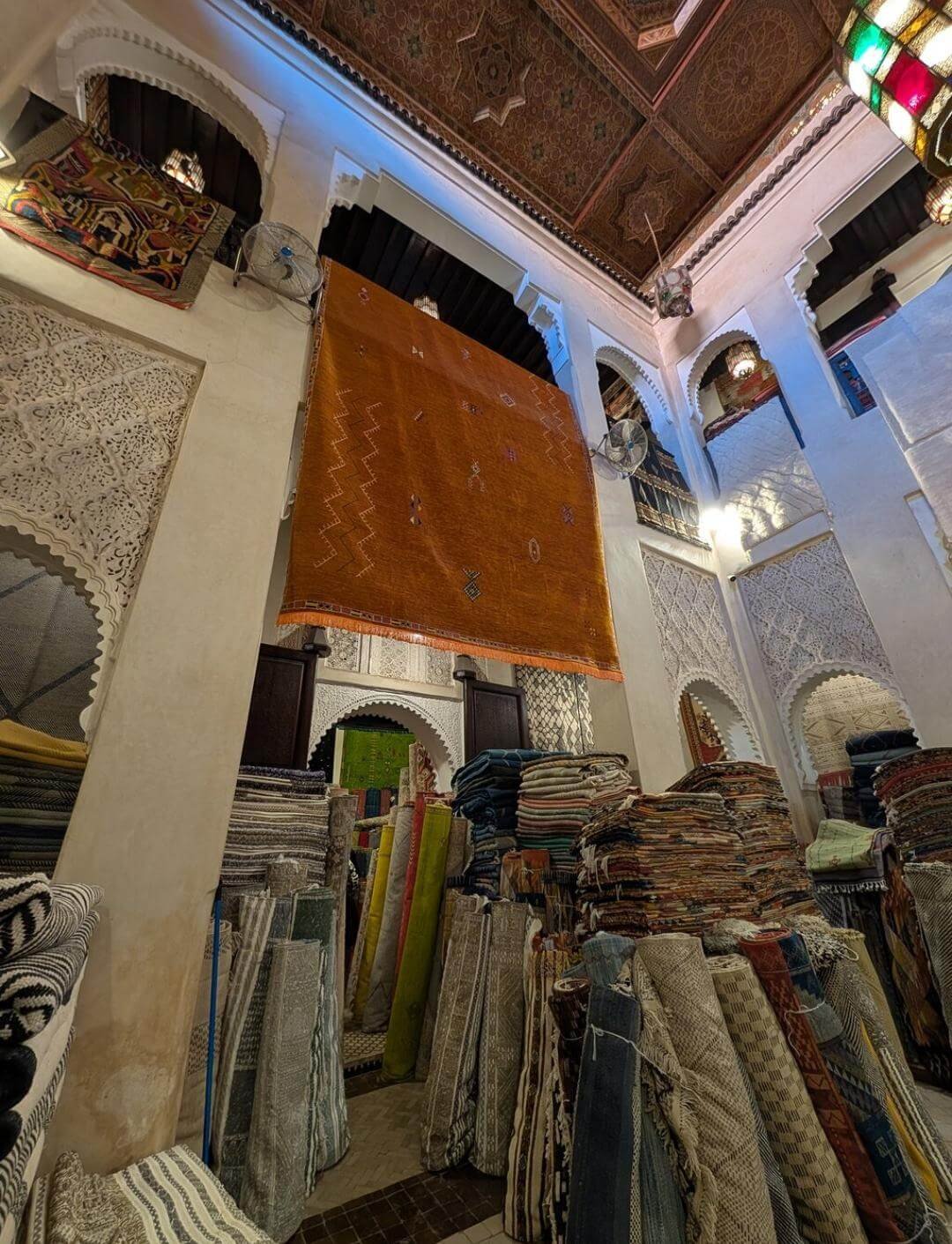 Rolled fabrics displayed in a traditional Marrakech shop