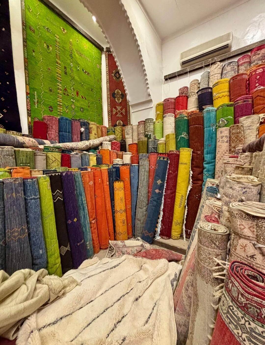 Colorful fabrics displayed in Marrakech souk shop