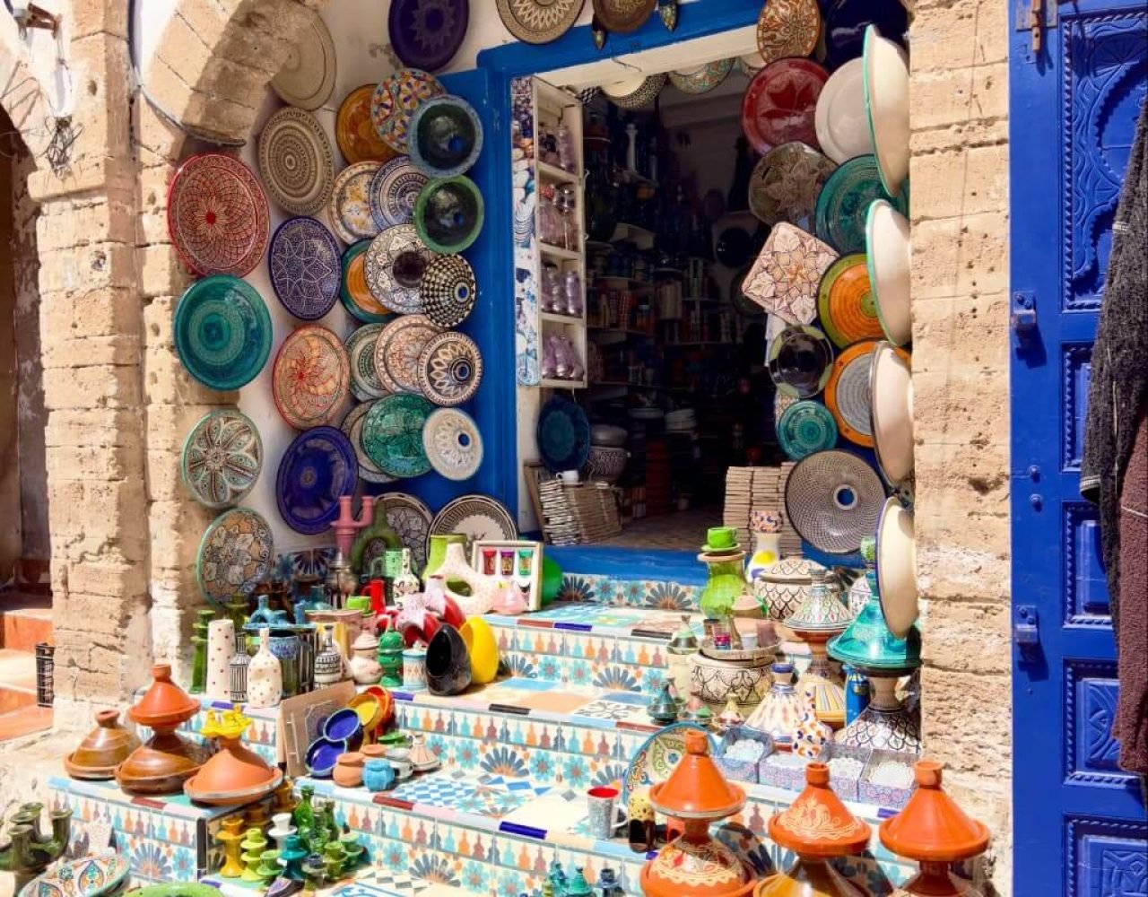 Shop displaying traditional Moroccan tagines and ceramic pottery in Essaouira