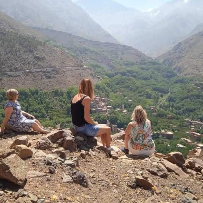 Travelers arriving in Imlil village, Atlas Mountains valley view