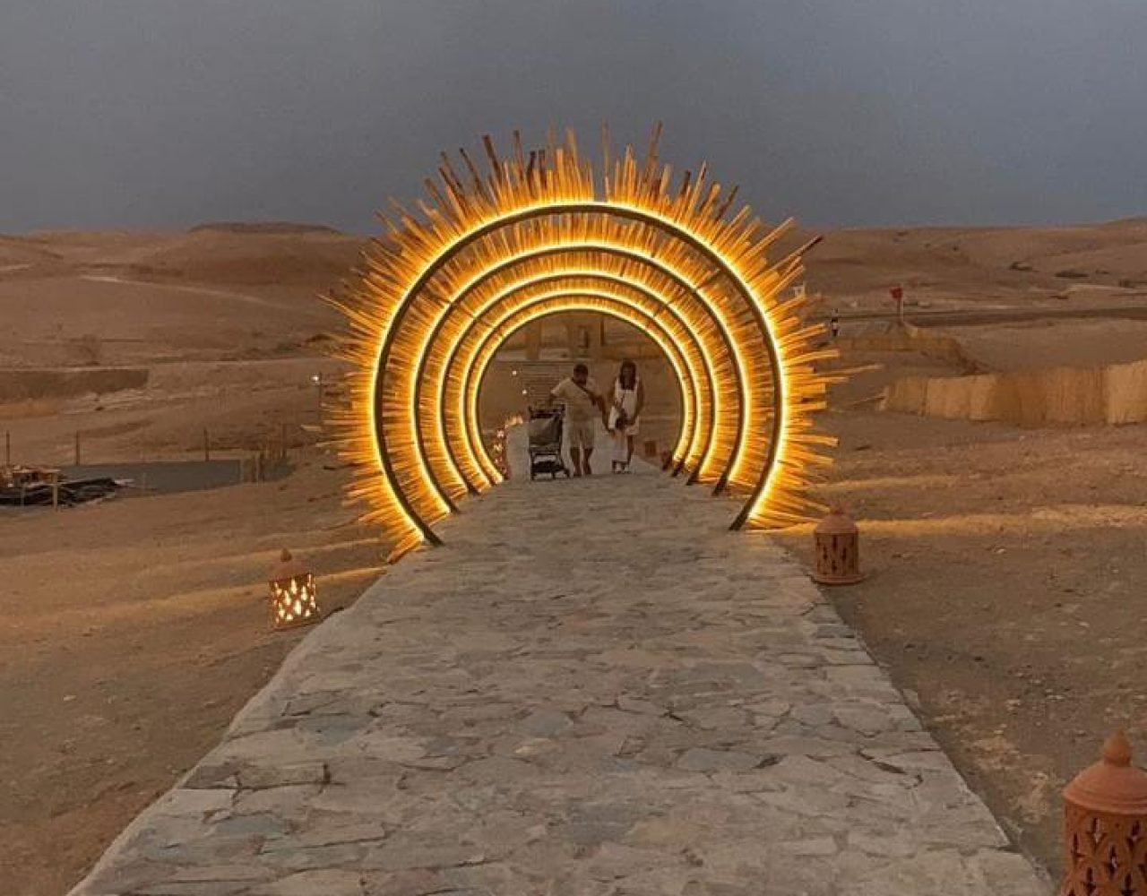 Glowing circular light installation forming a tunnel in the Agafay Desert