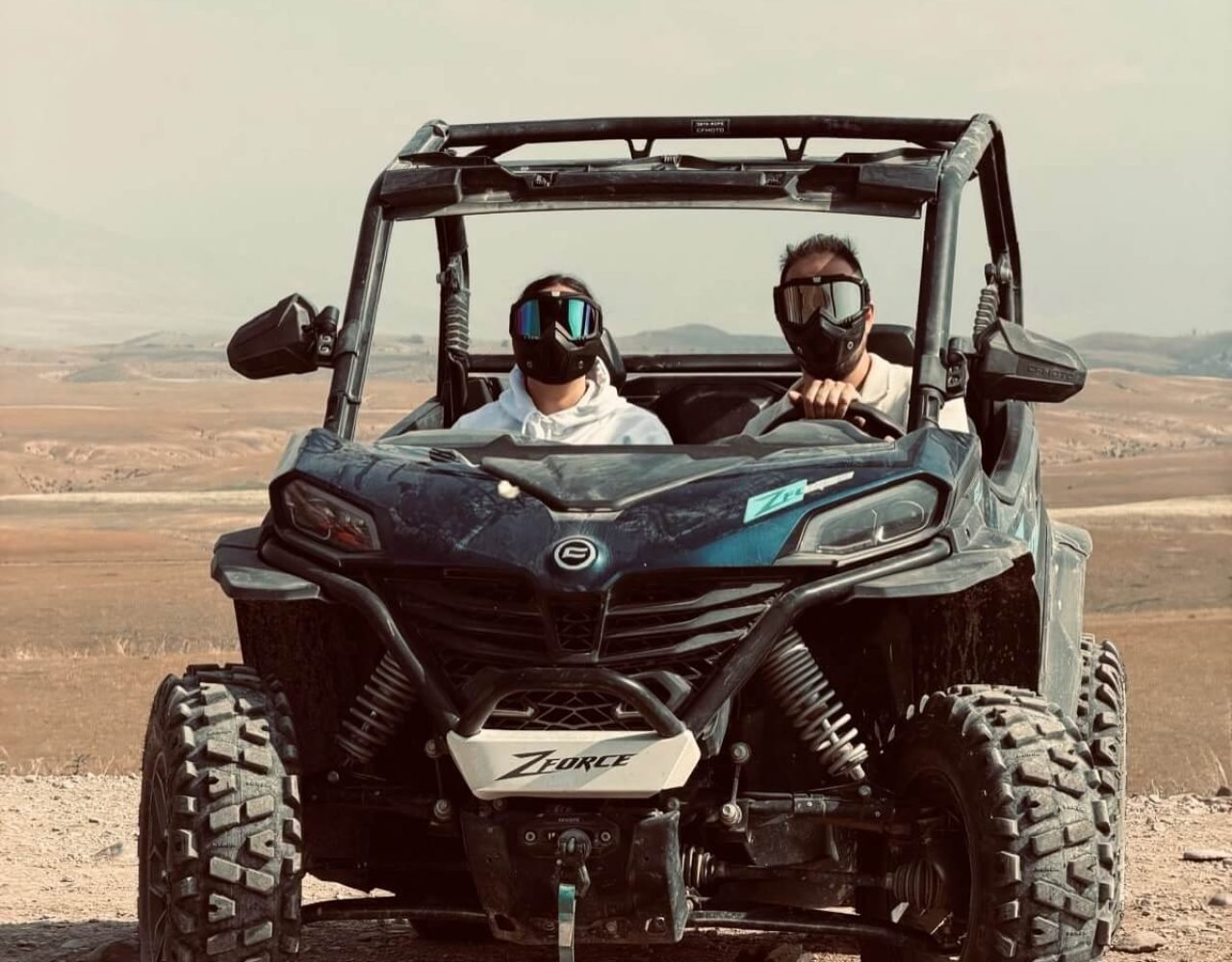 Off-road dune buggy with two passengers in the Agafay Desert