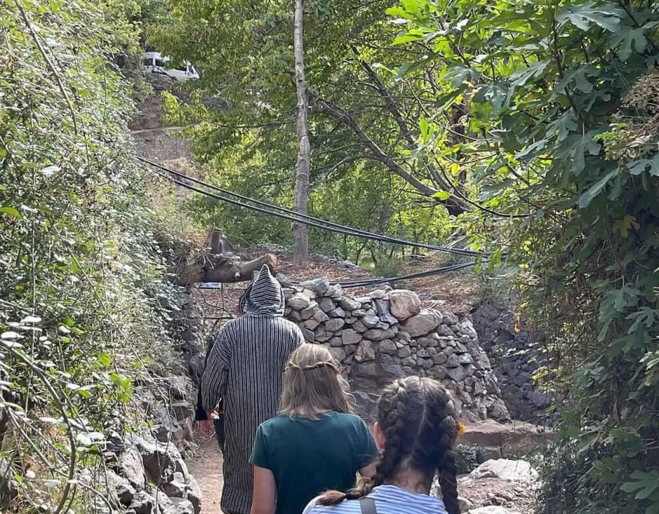 Travelers hiking through the Atlas Mountains near Imlil
