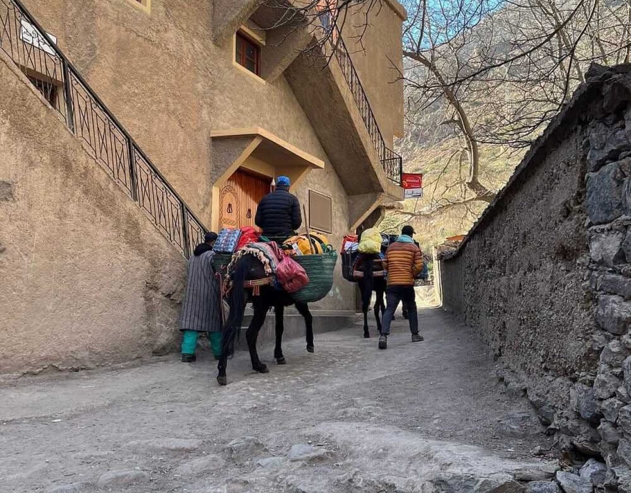 Travelers riding mules through the Atlas Mountains near Imlil