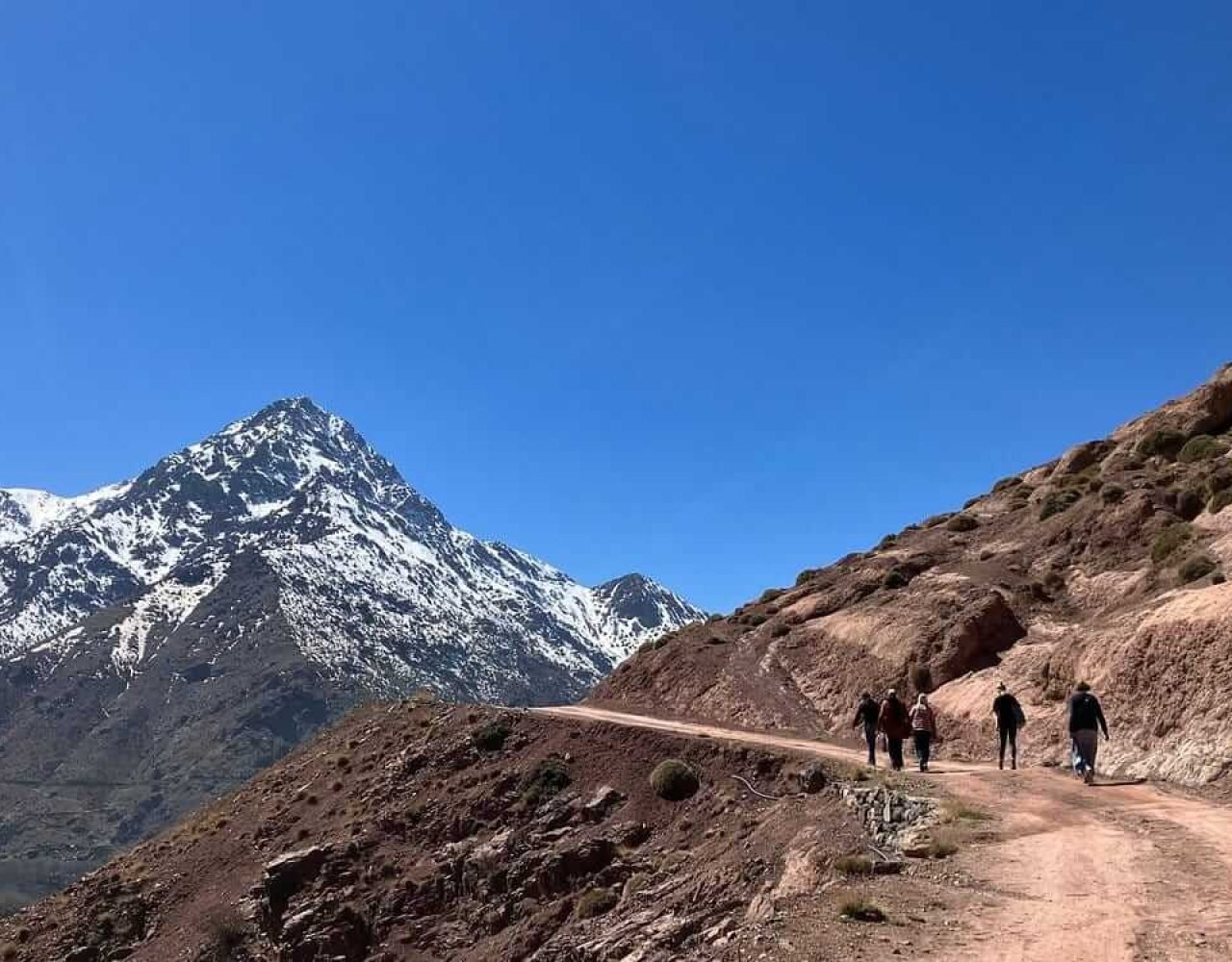 Travelers walking through the Atlas Mountains near Imlil