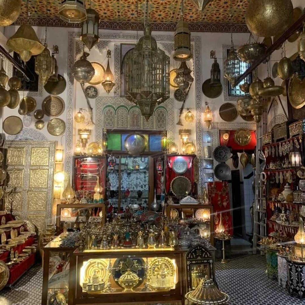 Traditional Moroccan lanterns and brassware inside Marrakech souk shop