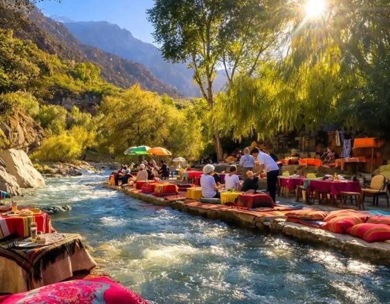 Traditional riverside seating over Ourika river surrounded by trees near Marrakech