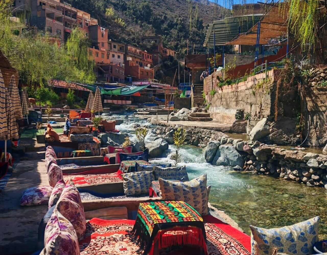 Red cushion seating with traditional rugs by Ourika river