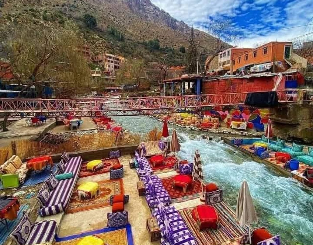 Aerial view of colorful cushions and mats over Ourika river