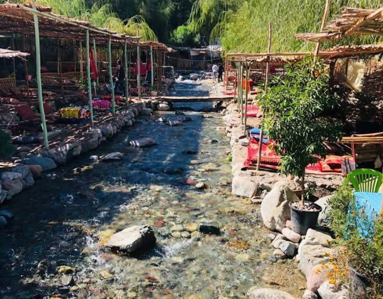 River water flowing over rocks next to an orange-toned lounge